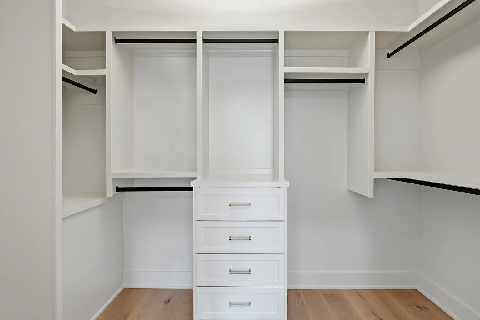 Custom walk-in closet with oak cabinetry